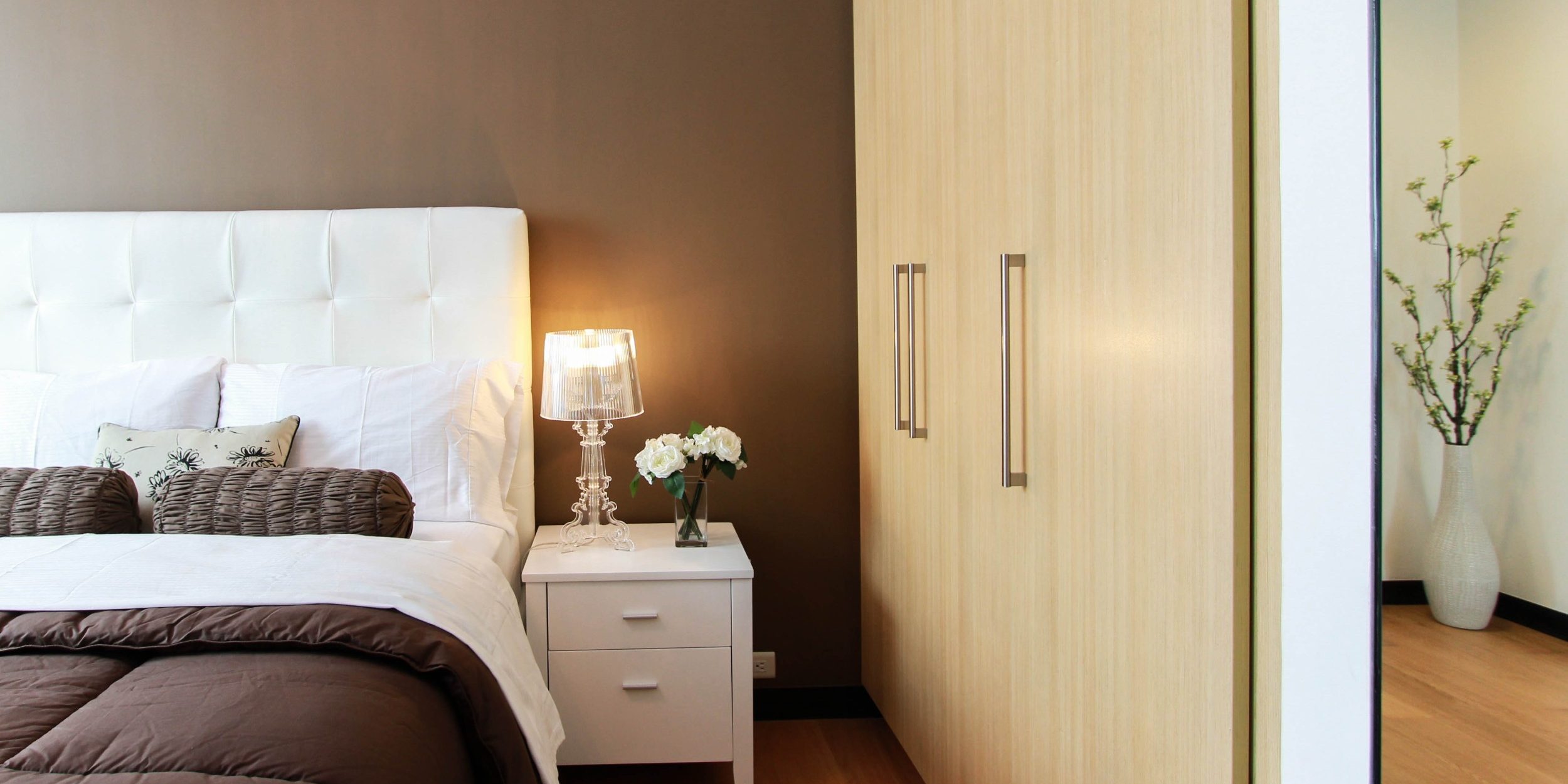 freshly made bed and closet