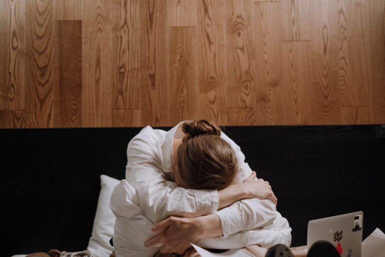 overwhelmed woman sitting in a mess of stuff