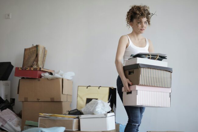 overwhelmed woman moving boxes