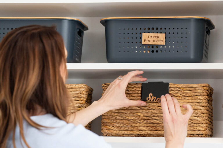 Professional Organizer labeling bins on shelves